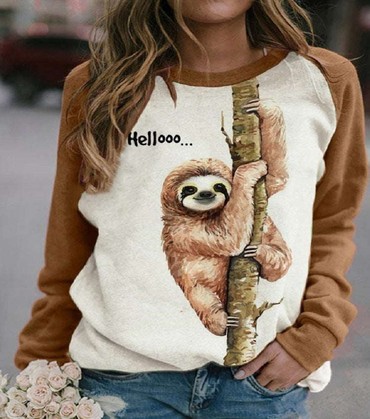 A casual long-sleeved Urban Vibes Hedging Top with a print of a smiling sloth hanging from a tree, with the text 'Helloo.