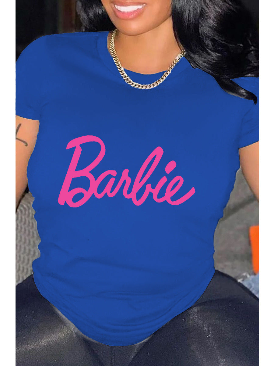 A person wearing a blue relaxed fit t-shirt with the pink 'Barbie' text graphic printed on the front.