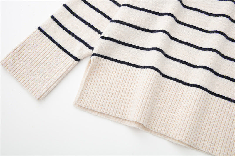 A woman wearing a beige and black striped knit pullover.