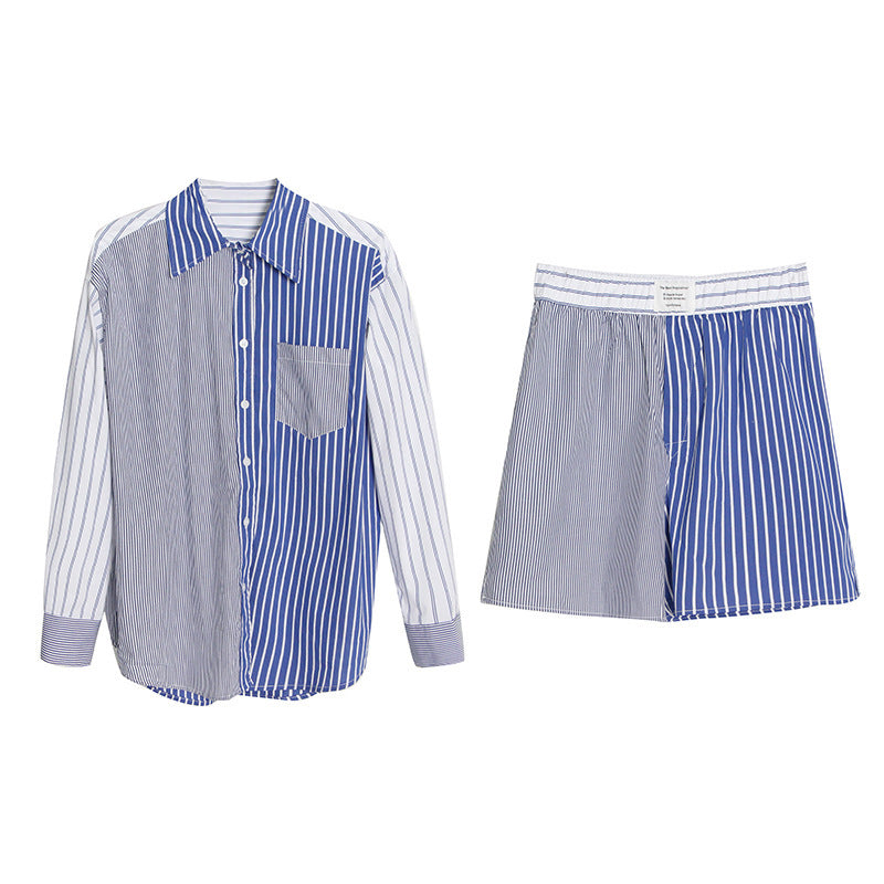 A woman wearing a long-sleeve shirt and shorts set with a striped pattern, paired with a black hat and sunglasses.