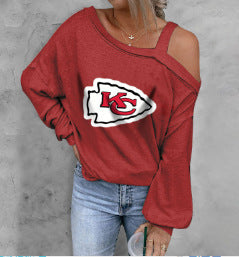 Red sweatshirt with a logo worn by a person against a gray background