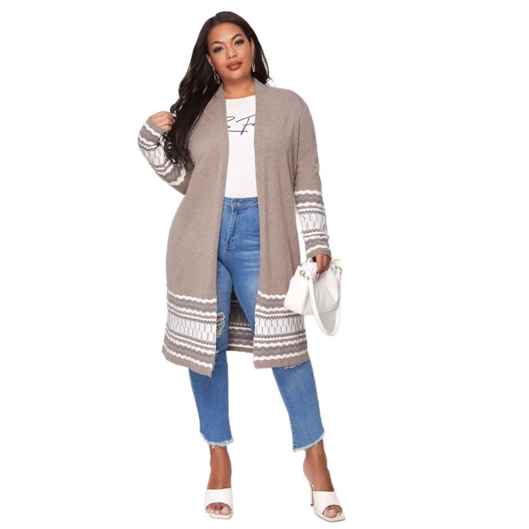 A woman wearing a black and multicolored Eloise Comfort Fit Cardigan with sequined detailing, paired with a white top and brown pants, standing on the street.