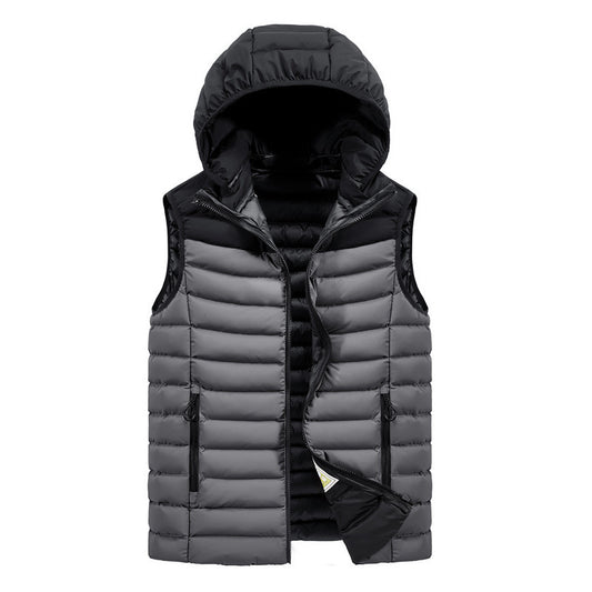 A hooded vest with a ribbed bottom hem and a reversible design featuring a different pattern on the inside. The vest is primarily dark blue with a black hood, and zipper closure.