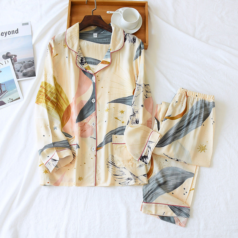 A Luxe Lapel Oversized Cardigan in white with a leaf pattern, displayed on a white background with a wooden hanger and a cup.