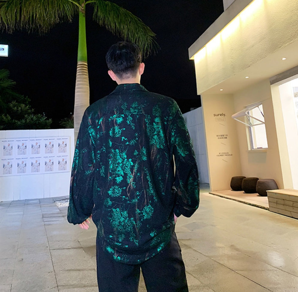 A person wearing a floral print hip hop top with a round neckline and long sleeves.