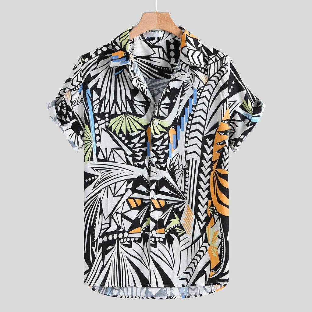 A short-sleeved Urban Luau shirt with a geometric pattern featuring black, white, yellow, and blue colors, displayed on a wooden hanger.