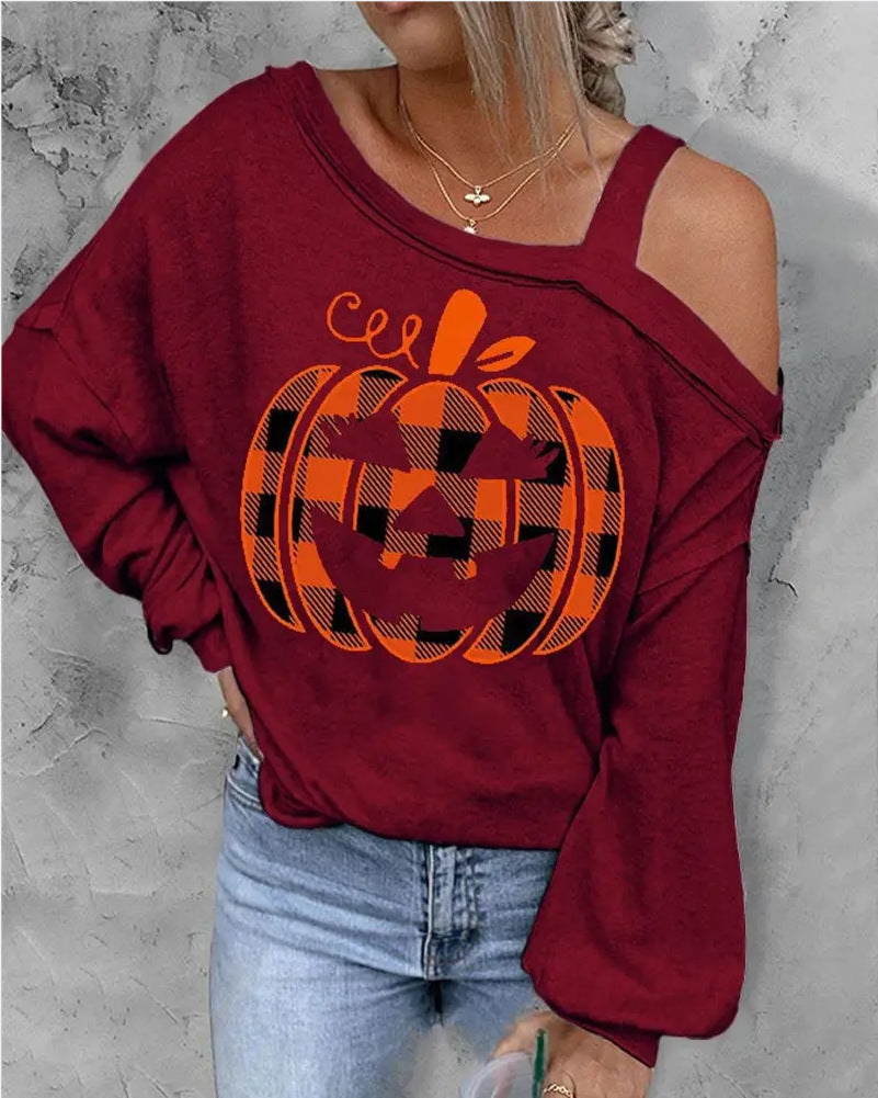 Red sweatshirt with plaid pumpkin design worn by a person on a gray background