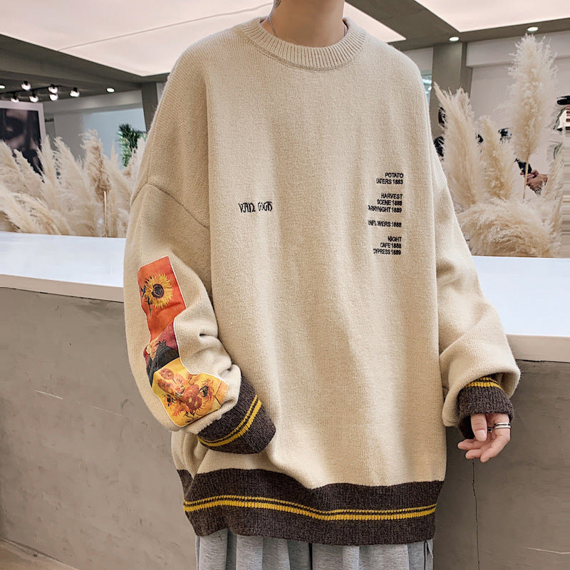 A person wearing a brown 'Tokyo Drift Knitwear' sweater with a round neckline and long sleeves. The sweater features text and design elements in gray and yellow on the front.