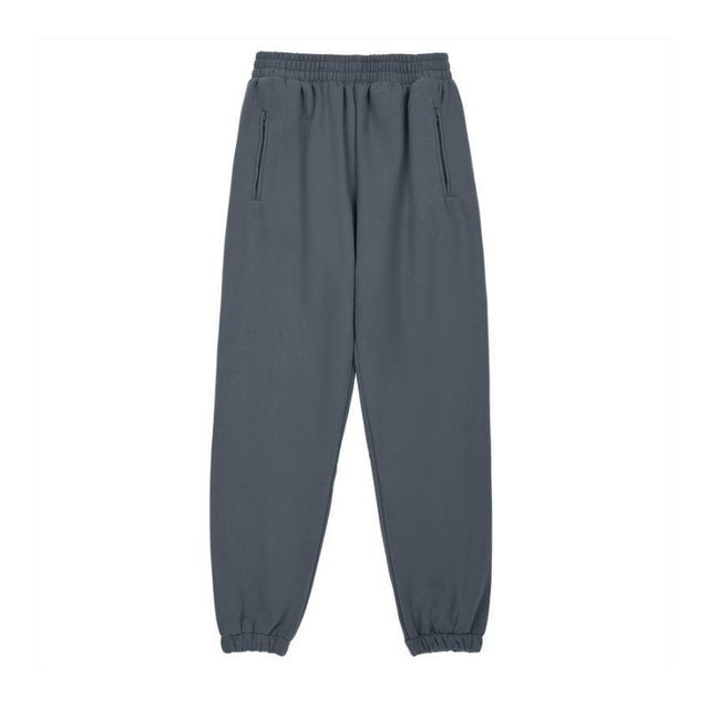 A person wearing a dark grey Urban Fade Washed Pullover Hoodie with a high hood and oversized fit, paired with black pants. The hoodie has a washed character print on the front.