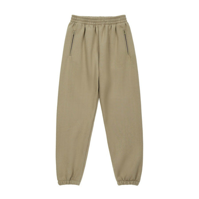 A person wearing a dark grey Urban Fade Washed Pullover Hoodie with a high hood and oversized fit, paired with black pants. The hoodie has a washed character print on the front.