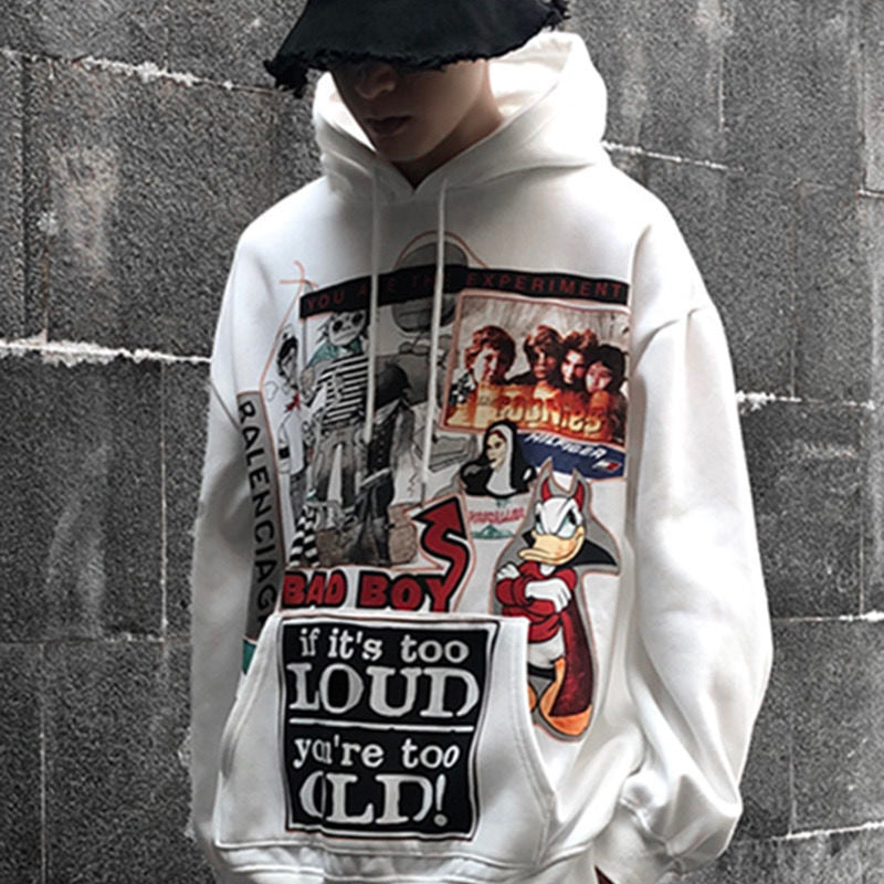 A person wearing a gray Urban Rebel graphic sweatshirt with a hood, featuring a bold, cartoon-inspired design.