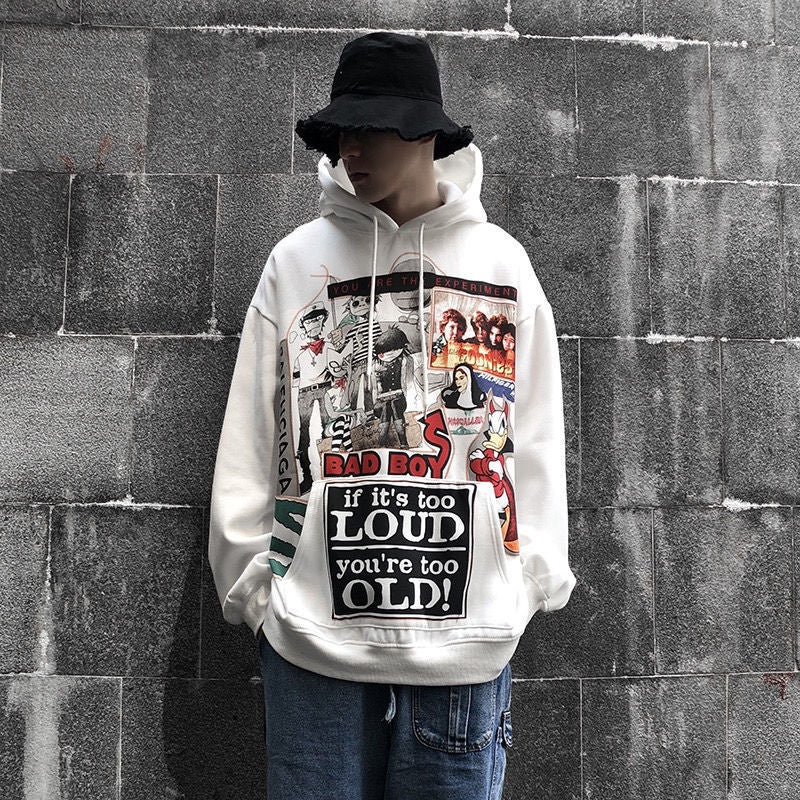 A person wearing a gray Urban Rebel graphic sweatshirt with a hood, featuring a bold, cartoon-inspired design.