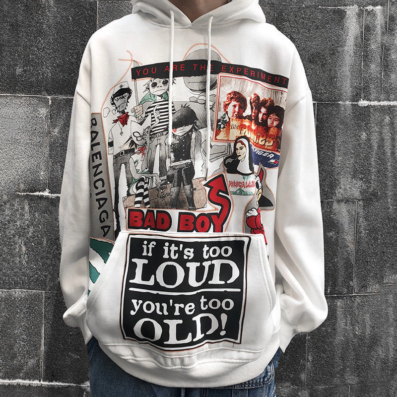 A person wearing a gray Urban Rebel graphic sweatshirt with a hood, featuring a bold, cartoon-inspired design.
