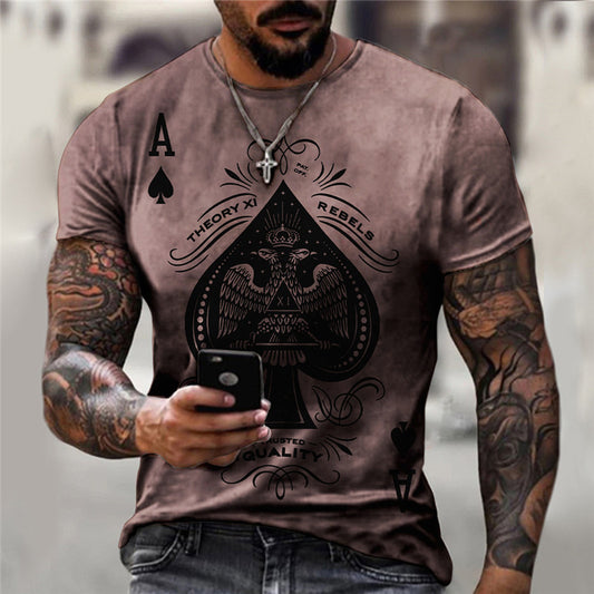 A person with tattoos wearing a brown short-sleeve t-shirt with a playing card motif of the King of Spades.