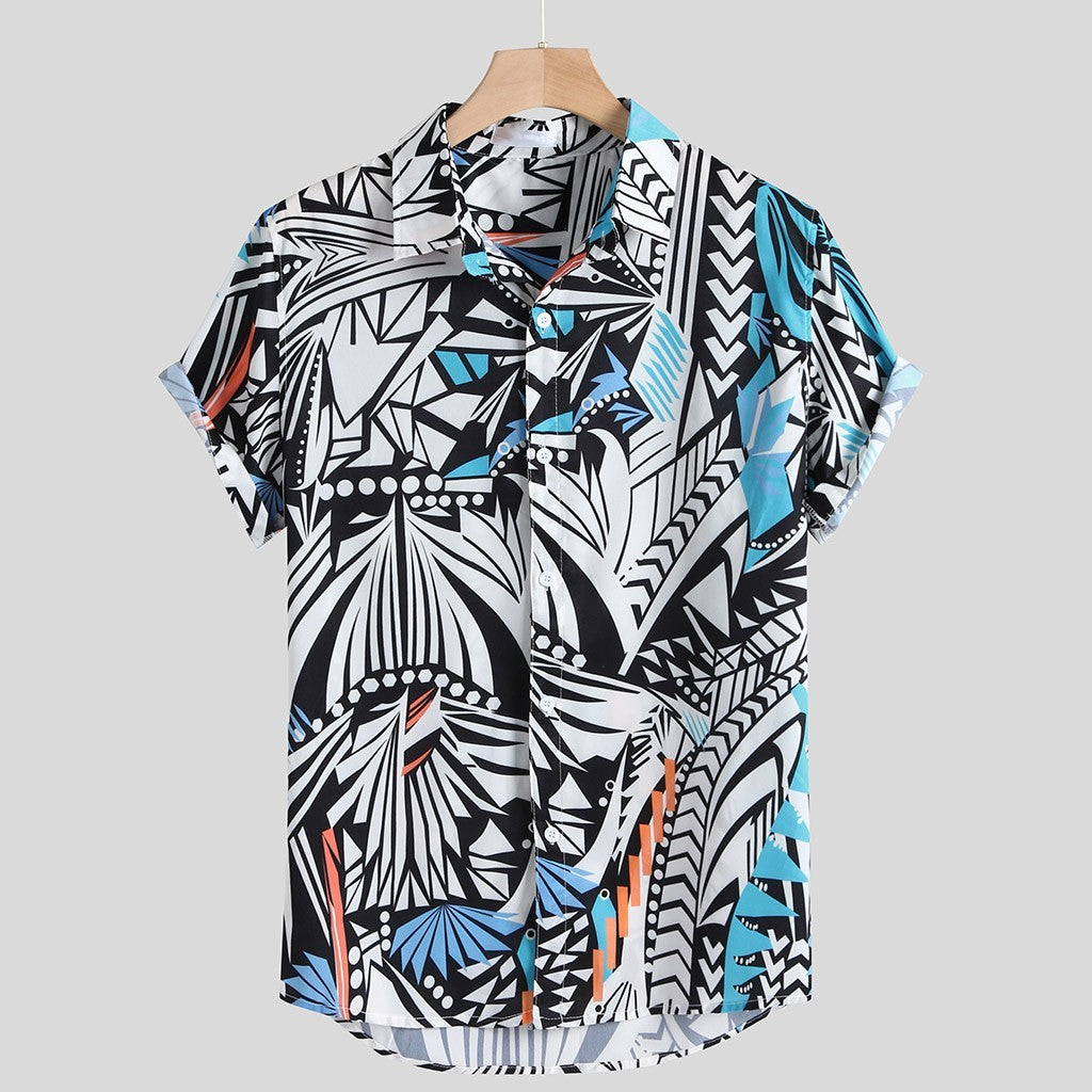 A short-sleeved Urban Luau shirt with a geometric pattern featuring black, white, yellow, and blue colors, displayed on a wooden hanger.