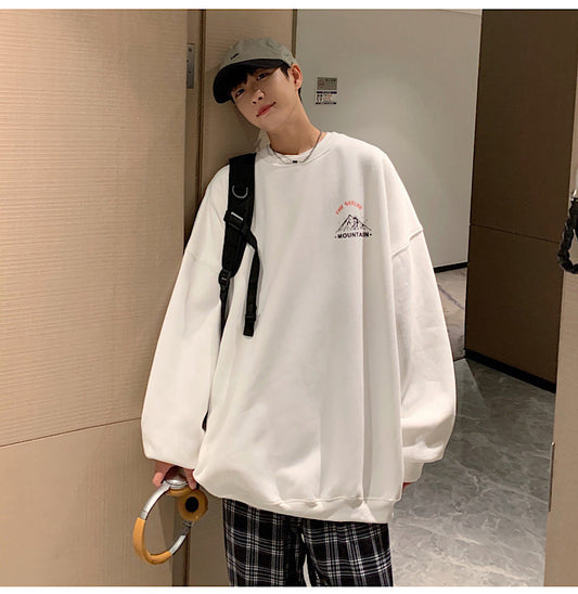 A person wearing a white Tide Core Urban Pullover hoodie with a round neckline and long sleeves, paired with plaid pants and a baseball cap.
