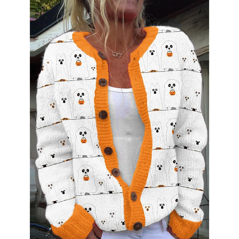 White cardigan with orange trim and ghost pattern worn by a person.