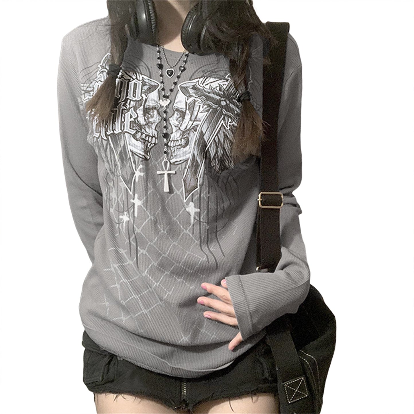 Person wearing a gray hoodie with graphic designs and black shorts on a white background