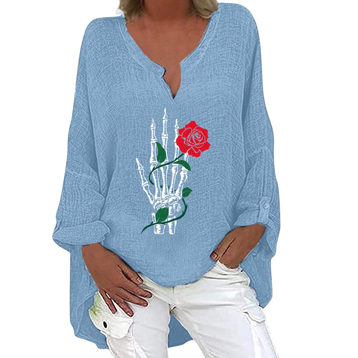Blue long-sleeve shirt with skeleton hand and rose design worn by a person.