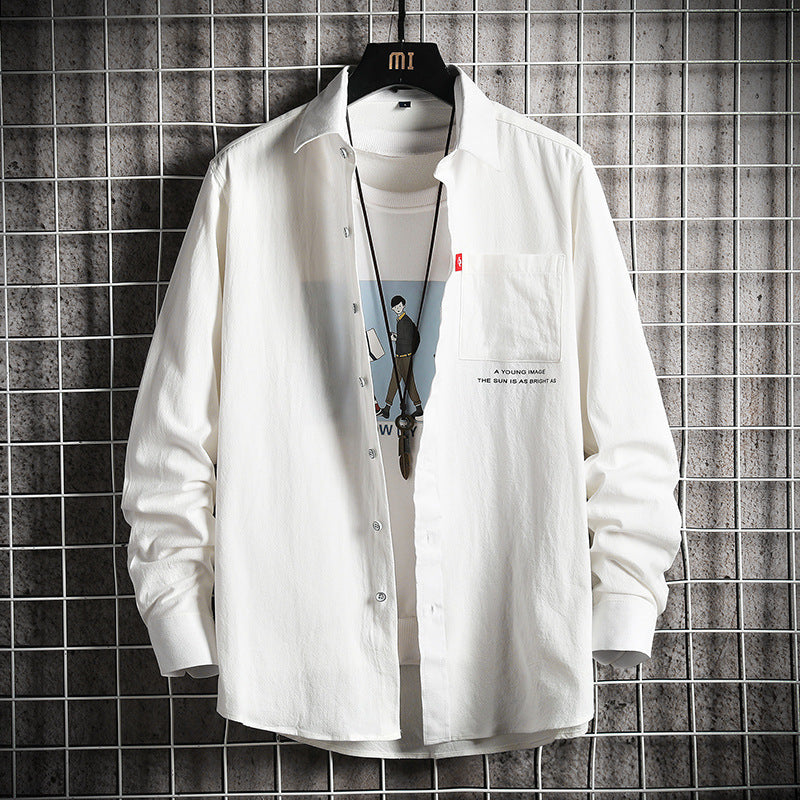 A male fashion model wearing a white Urban Wave men's fashion top with a lapel collar, long sleeves, and a slim fit. The top is displayed in an urban setting with a tiled wall in the background.