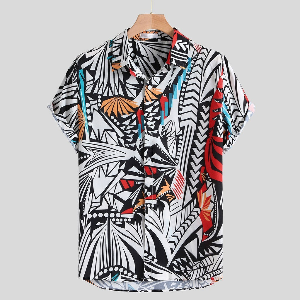 A short-sleeved Urban Luau shirt with a geometric pattern featuring black, white, yellow, and blue colors, displayed on a wooden hanger.