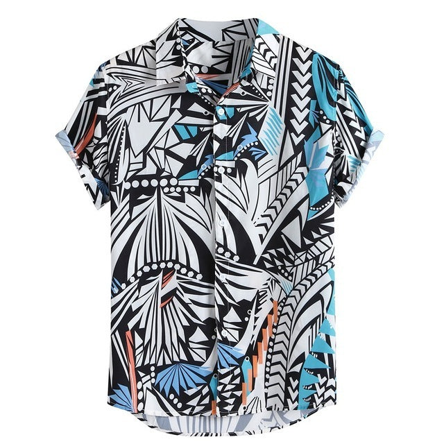 A short-sleeved Urban Luau shirt with a geometric pattern featuring black, white, yellow, and blue colors, displayed on a wooden hanger.