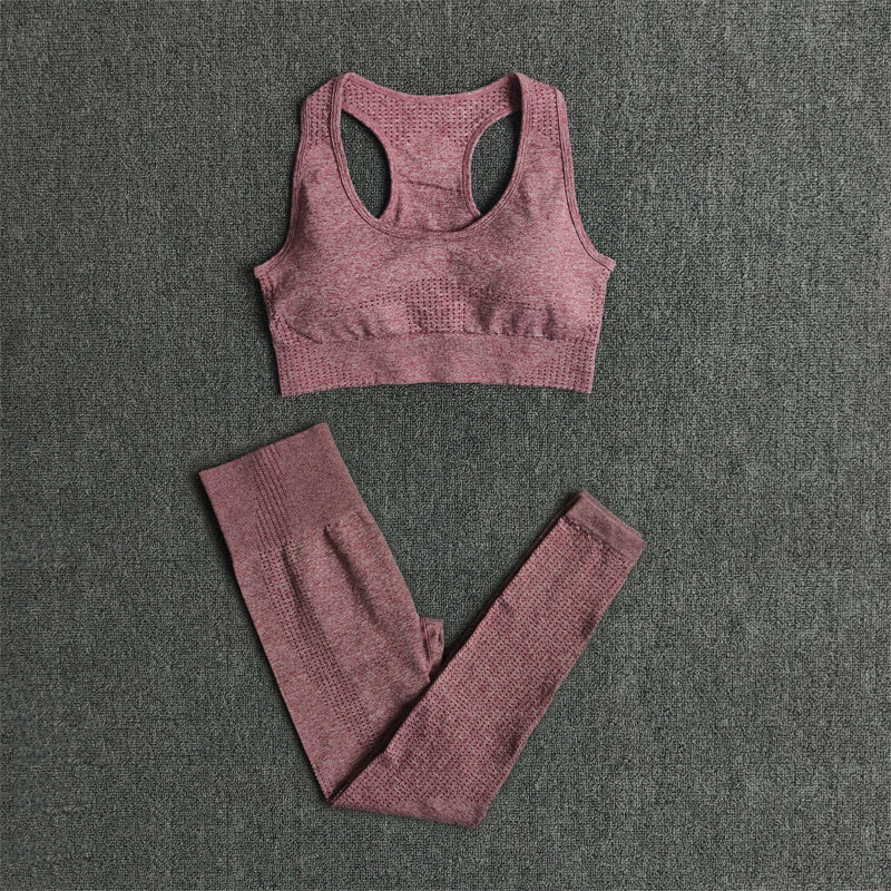 Pink sports bra and leggings set on a gray textured background