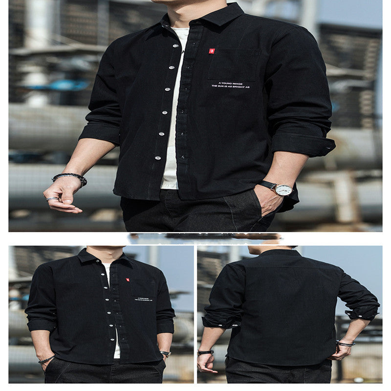 A male fashion model wearing a white Urban Wave men's fashion top with a lapel collar, long sleeves, and a slim fit. The top is displayed in an urban setting with a tiled wall in the background.