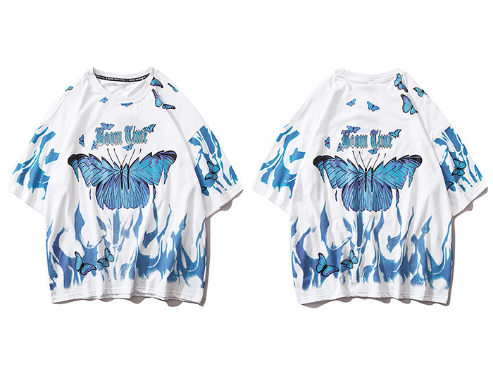 A person wearing a black round neck t-shirt with a graphic print of blue and purple butterflies.