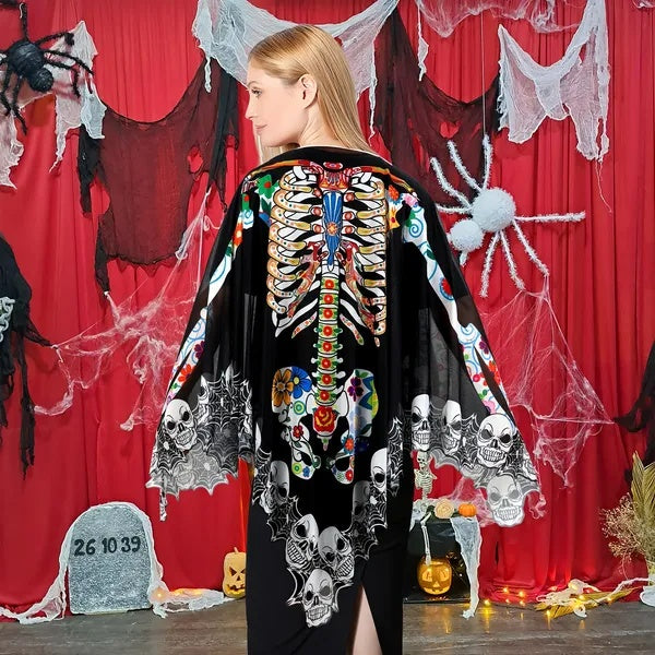 Person wearing a colorful skeleton and skull patterned jacket against a Halloween-themed backdrop.