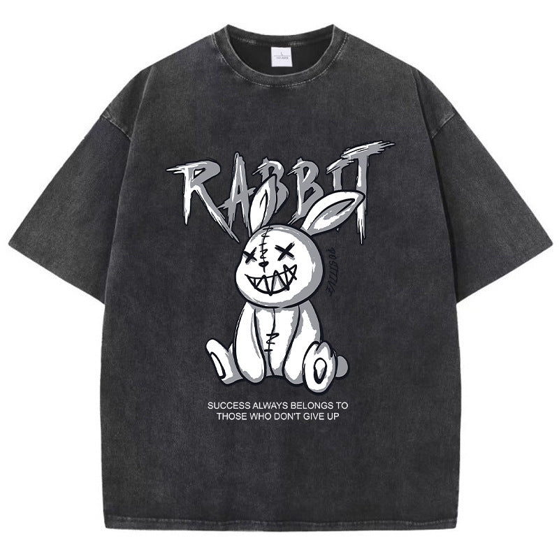 A black T-shirt featuring a graphic print of a stylized rabbit with the text 'RABBIT' above it. The graphic has a black and white color scheme.