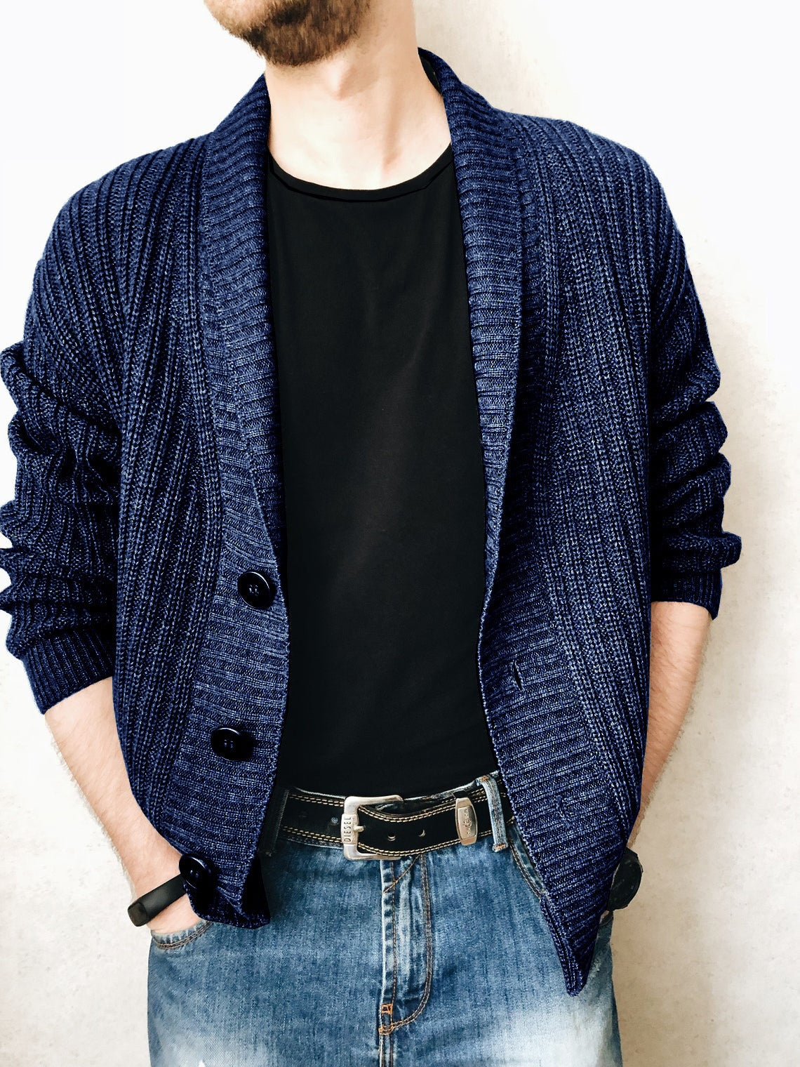 A person wearing a brown Urban Knit V-Neck Cardigan over a black t-shirt and blue jeans.