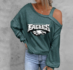 Green sweatshirt with Eagles logo worn by a person on a gray background