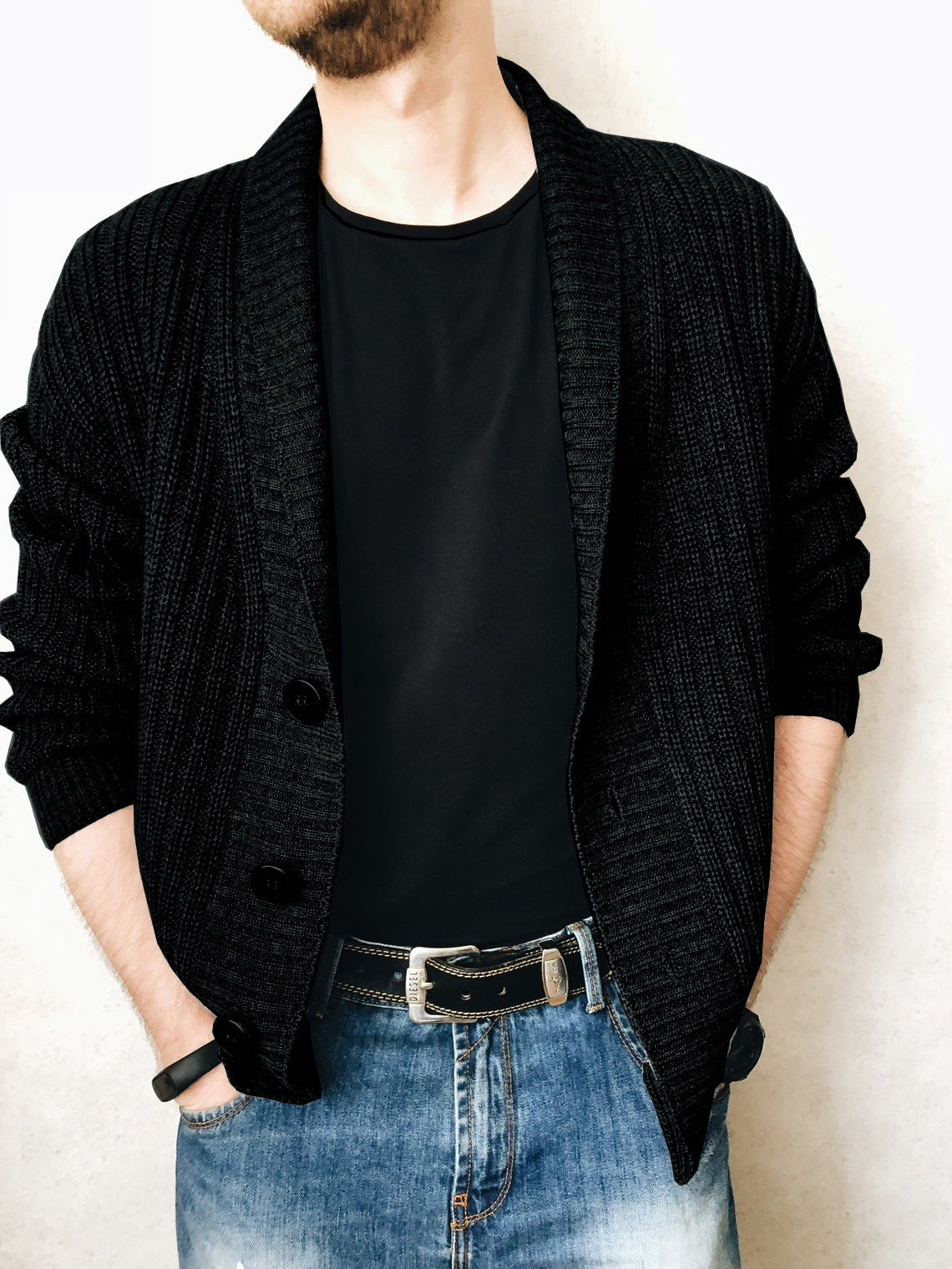 A person wearing a brown Urban Knit V-Neck Cardigan over a black t-shirt and blue jeans.