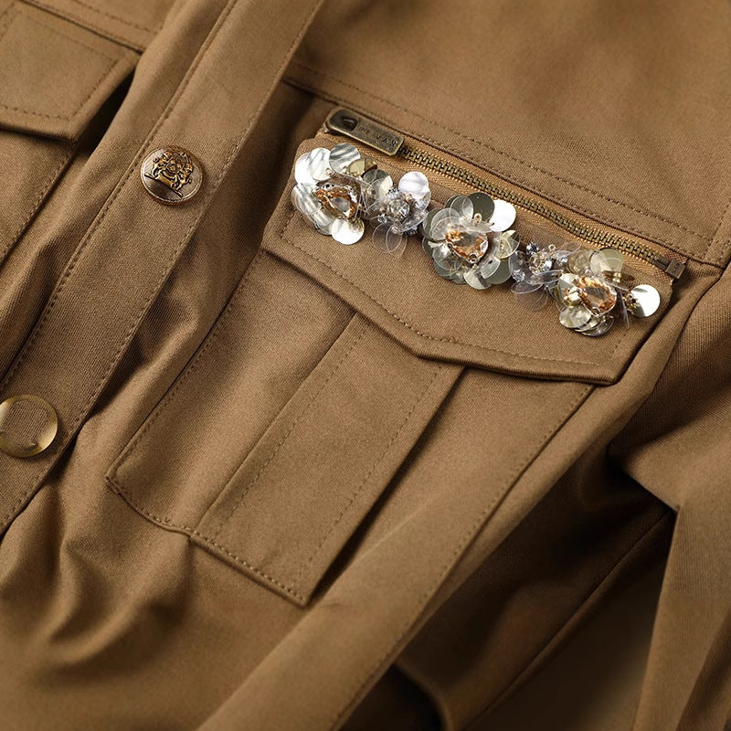 A belteds work dress with plant and flower embroidery on the chest area, in a mid-length style with a high waist and short sleeves, in a khaki color.