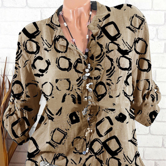 A person wearing a long-sleeved pullover shirt with a geometric all-over print in black and khaki colors.