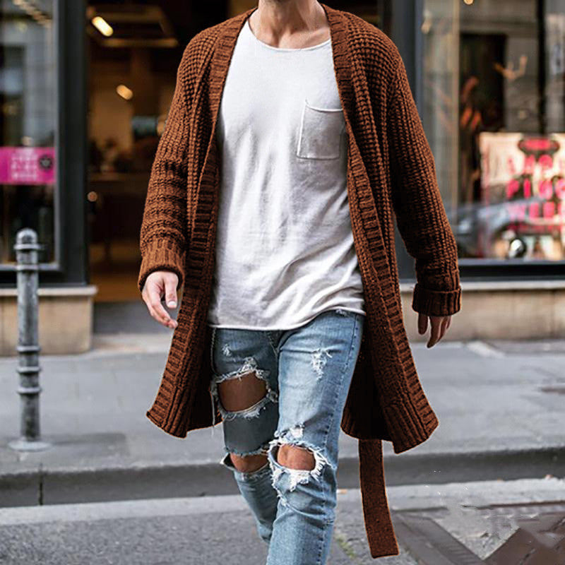 A cozy fit solid cardigan in brown color, paired with a white t-shirt and blue ripped jeans.