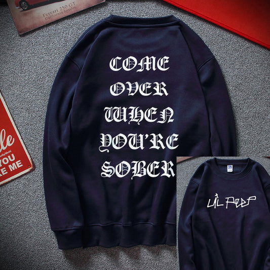 A black fleece sweatshirt with white text on the back reading 'COME OVER WHEN YOU'RE SOBER' and the brand name 'LIL PEEP' on the front.
