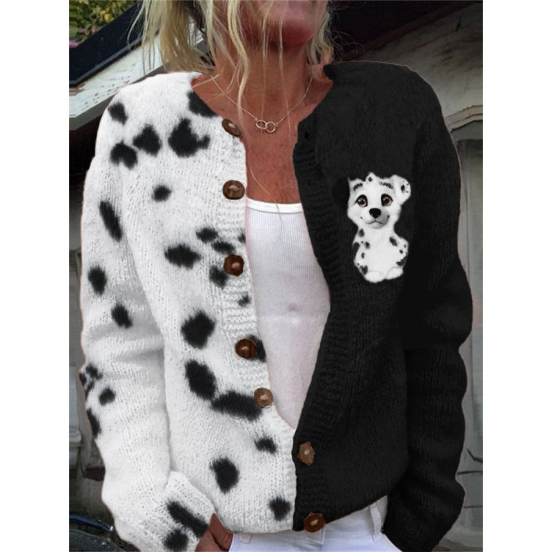 Person wearing a black and white patterned cardigan with a small dog design.
