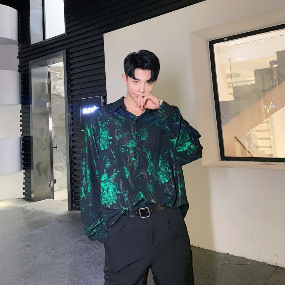 A person wearing a floral print hip hop top with a round neckline and long sleeves.