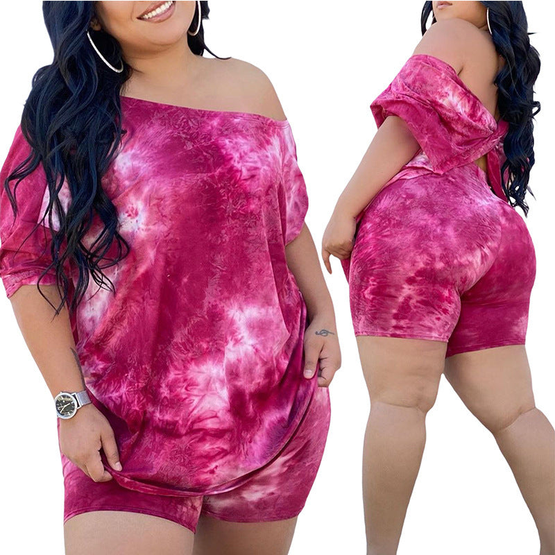 A model wearing a red and pink tie-dye print top and shorts set.