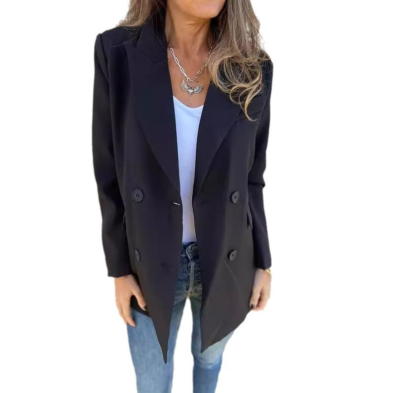 A woman wearing a black Urban Grace Lapel Jacket with a white top and blue jeans. She has accessorized with a necklace and has convenient pockets on the jacket.