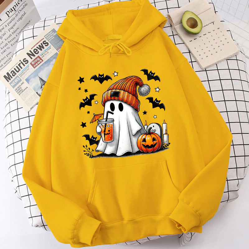 Yellow hoodie with Halloween-themed design featuring a ghost, pumpkins, and bats on a checkered surface.