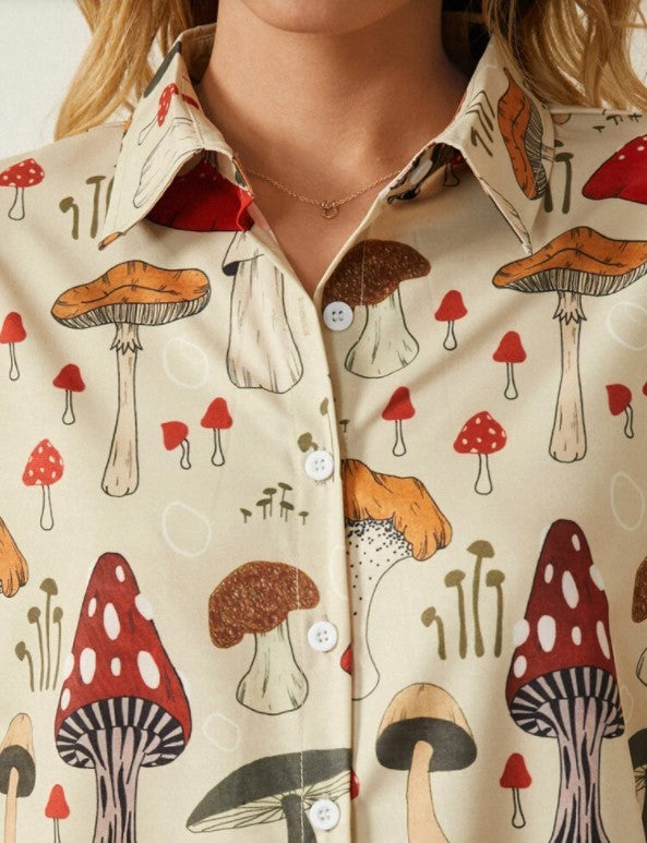 A woman wearing a yellow Urban Casual Lapel Shirt with a mushroom print, paired with blue jeans and a brown belt.