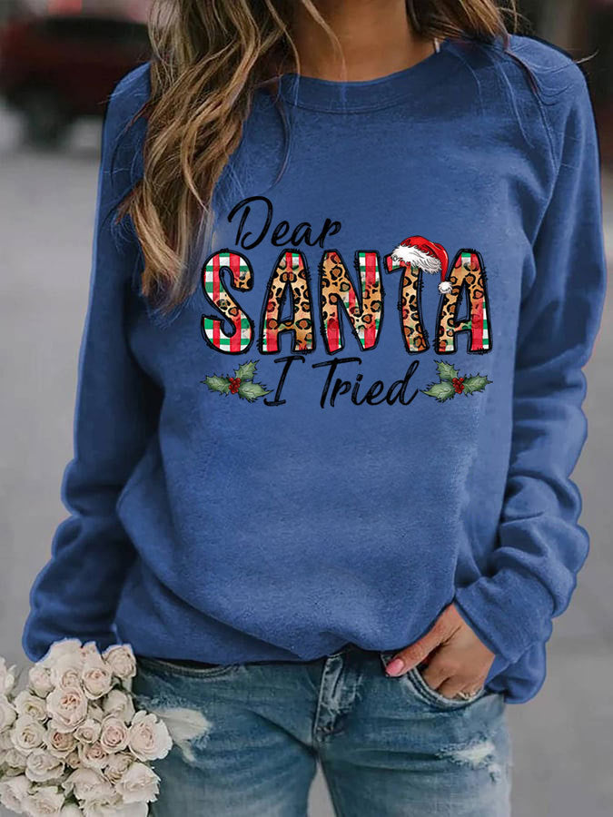 Blue sweatshirt with 'Dear Santa I Tried' text, worn by a person holding flowers.