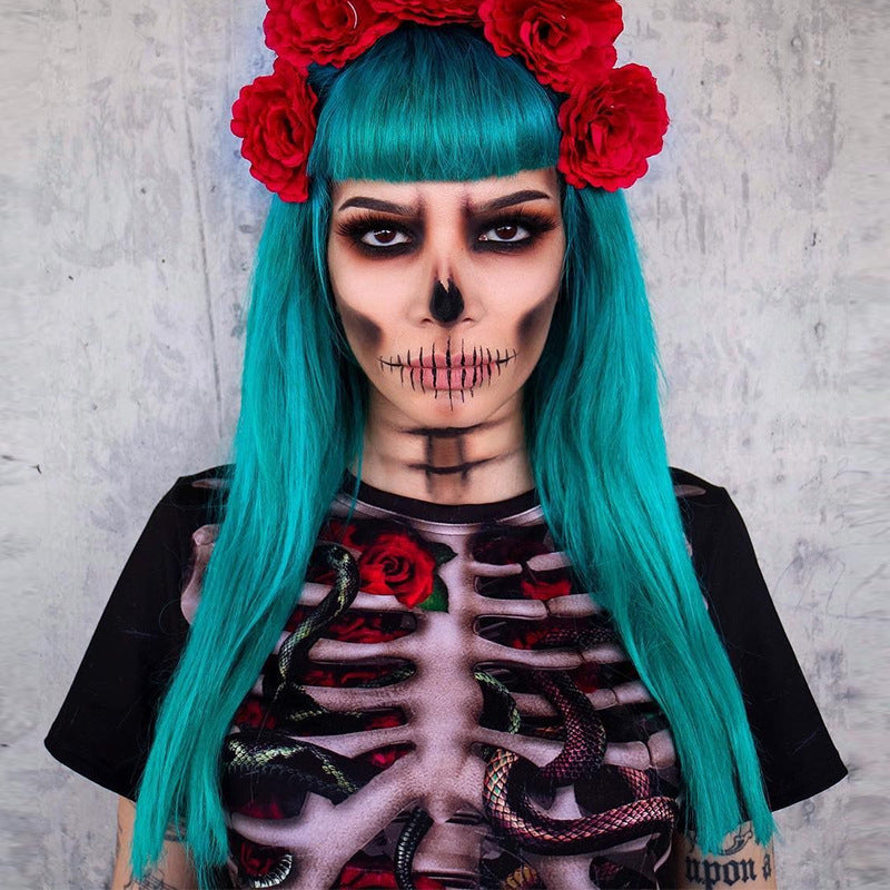 Person with teal hair and red flowers, wearing a skeleton-themed outfit against a gray background
