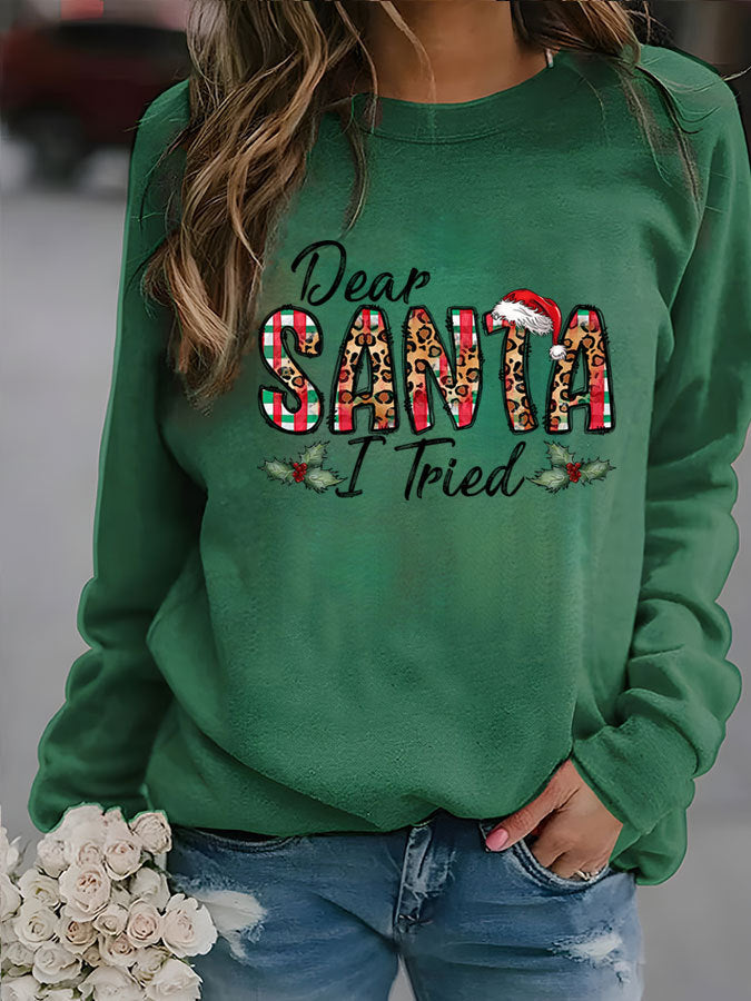 Green sweatshirt with 'Dear Santa I Tried' text and leopard print letters, worn by a person.