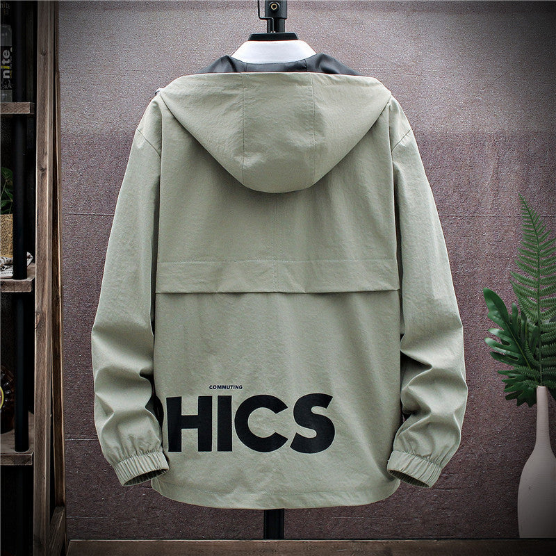 A plus-sized gray jacket with a hood, featuring white graphic prints on the chest and a zipper closure. The jacket is displayed on a mannequin against a room setting with a decorative plant and a wall.