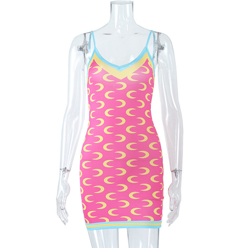 A woman wearing a sleeveless, high-waisted, bodycon print dress in blue with orange accents, standing inside a clothing store.