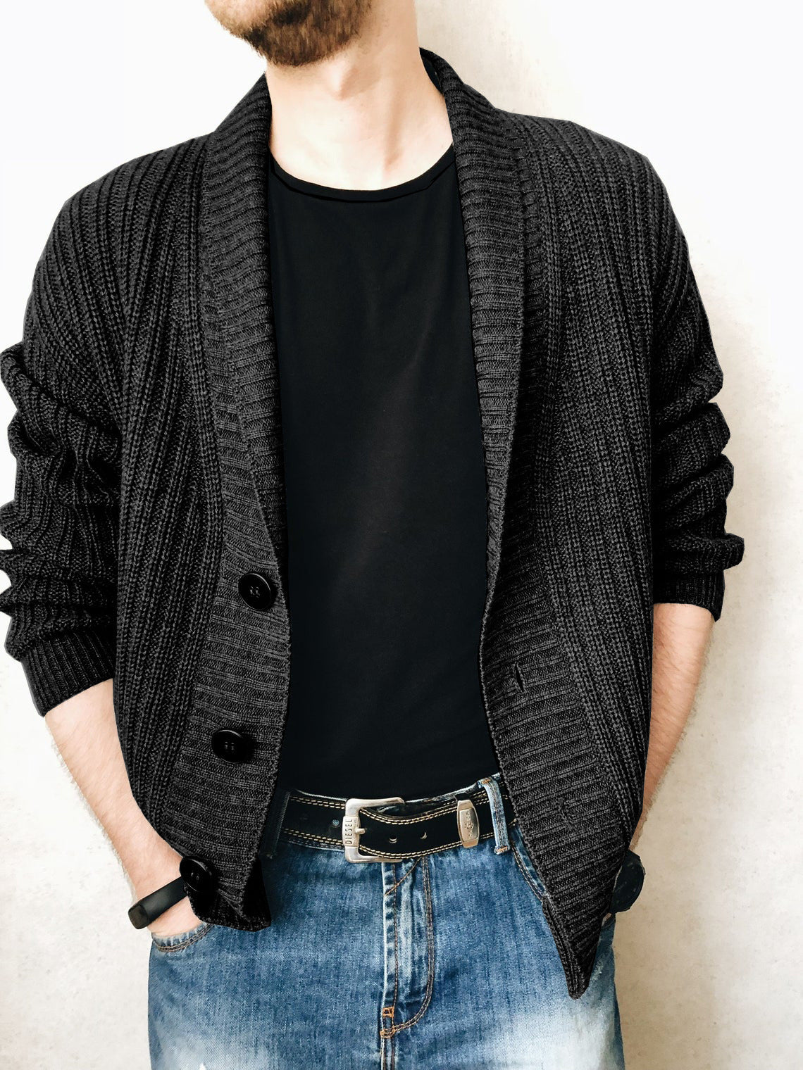 A person wearing a brown Urban Knit V-Neck Cardigan over a black t-shirt and blue jeans.